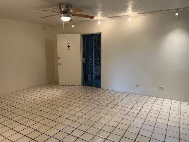A room with a tiled floor and a ceiling fan.